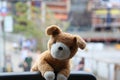 Cute plush toy perched on a window sill.