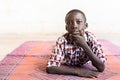 Cute Portrait Shot of Little African Boy Posing with Hand under Chin