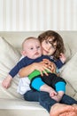 Cute portrait of sister and brother holding each other. Royalty Free Stock Photo