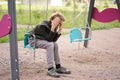 Cute positive boy teenager on the Playground in the city alone Royalty Free Stock Photo