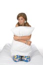 Cute pre-teen girl on mattress holding pillow Royalty Free Stock Photo
