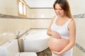 A cute pregnant woman in the bathroom Royalty Free Stock Photo