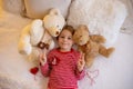 Cute preschool boy, playing with white and red bracelets. Martenitsa, white and red strains of yarn, Bulgarian folklore tradition Royalty Free Stock Photo