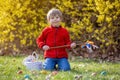 Cute preschool child, boy, holding handmade braided whip made from pussy willow, traditional symbol of Czech Easter used for