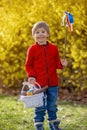 Cute preschool child, boy, holding handmade braided whip made from pussy willow, traditional symbol of Czech Easter used for