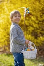 Cute preschool child, boy, holding handmade braided whip made from pussy willow, traditional symbol of Czech Easter used for