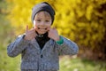 Cute preschool child, boy, holding handmade braided whip made from pussy willow, traditional symbol of Czech Easter used for