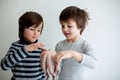 Cute preschool children, boy brothers, holding raw octopus Royalty Free Stock Photo