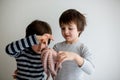 Cute preschool children, boy brothers, holding raw octopus Royalty Free Stock Photo