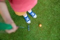 Cute preschool girl playing mini golf with family. Happy toddler child having fun with outdoor activity. Summer sport Royalty Free Stock Photo