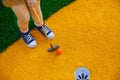 Cute preschool girl playing mini golf with family. Happy toddler child having fun with outdoor activity. Summer sport Royalty Free Stock Photo