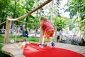 Cute preschool girl playing mini golf with family. Happy toddler child having fun with outdoor activity. Summer sport Royalty Free Stock Photo