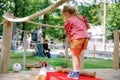 Cute preschool girl playing mini golf with family. Happy toddler child having fun with outdoor activity. Summer sport Royalty Free Stock Photo