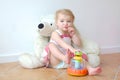 Cute preschooler girl playing games with her toys