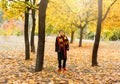 Cute pretty boy in costume of Harry Potter and scarf plays as a magician, reads book in autumn