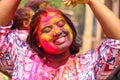 Cute pretty girl pouring colours on her face