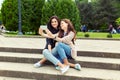 Two girls making funny selfie on the street, having fun together