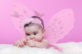 Cute, pretty, happy, chubby baby girl curious about her hands crossing eyes to focus Royalty Free Stock Photo