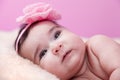 Cute, pretty, happy, chubby baby girl portrait smiling. Lying or on fluffy blanket.