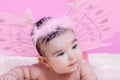 Cute, pretty, happy, chubby and smiling baby girl portrait, with pink butterfly wings Royalty Free Stock Photo