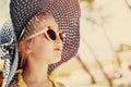 Fashion summer girl wearing a hat and posing for the camera. toned Royalty Free Stock Photo