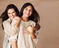 Cute pretty teen daughter with mature mothr hugging, fashion style brunette Royalty Free Stock Photo
