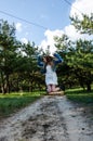 Cute and pretty young blond girl is jumping on the sand road Royalty Free Stock Photo