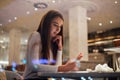 Cute and pretty young woman on smartphone in cafe Royalty Free Stock Photo