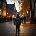 Cute primary school students back view on an evening street