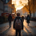 Cute primary school students back view on an evening street