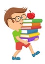 Cute primary schoolboy carrying stack books with red apple