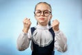 Cute Primary Schoolgirl Make Fist Blue Background