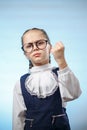 Cute Primary Schoolgirl Make Fist Blue Background Royalty Free Stock Photo