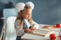 Cute Primary Schoolgirl in school uniform with white bows Read Tutorial Doing Homework, tutorial, ruler, Apple on the table. girl