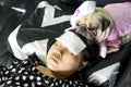 Cute pug dog with nurse costume take care of the owner, who is sleeping sick with a cold compress on the forehead. Love and Royalty Free Stock Photo