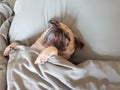 Cute pug dog sleep on pillow in the bed and wrap with blanket feel happy time