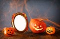 Cute pumpkins next to blank photo frame Royalty Free Stock Photo