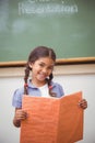 Cute pupil smiling at camera during class presentation Royalty Free Stock Photo