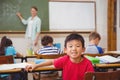 Cute pupil smiling at camera in classroom Royalty Free Stock Photo