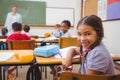 Cute pupil smiling at camera in classroom Royalty Free Stock Photo