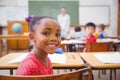 Cute pupil smiling at camera in classroom Royalty Free Stock Photo