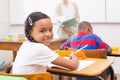 Cute pupil smiling at camera in classroom Royalty Free Stock Photo