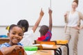 Cute pupil smiling at camera in classroom Royalty Free Stock Photo