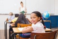 Cute pupil smiling at camera in classroom Royalty Free Stock Photo