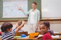 Cute pupil smiling at camera at his desk in classroom Royalty Free Stock Photo