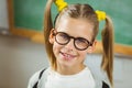 Cute pupil smiling to camera in a classroom Royalty Free Stock Photo