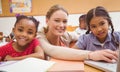 Cute pupil using computer with teacher