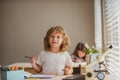 Cute pupil writing at desk in classroom at the elementary school. Student boy doing test in primary school. Children Royalty Free Stock Photo