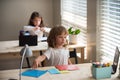 Cute pupil writing at desk in classroom at the elementary school. Student boy doing test in primary school. Children Royalty Free Stock Photo