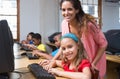 Cute pupils in computer class with teacher